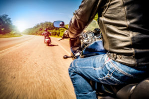 Man Driving Motorcycle Following Other Man Driving Motorcycle